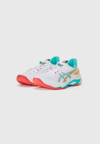 White athletic shoes with turquoise and coral accents, featuring a textured mesh upper, metallic logo design, and rubber outsole.