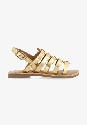 Gouden metalen sandalen met platte zool, verstelbare enkelriem en een zachte binnenvoering. Voorzien van meerdere platte bandjes over de voet.