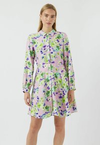 Blommig klänning med lätt tyg i rosa, grön och lila färger, knappframsida och långa ärmar med elastiska manschetter.