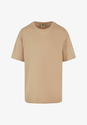 Beige kortermet T-skjorte laget av ribbestrikket stoff, med rund hals og en avslappet passform. Enkel, ren design.