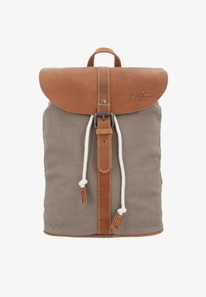 Mochila con cuerpo de tela gris, solapa y correa de cuero marrón aseguradas con hebilla metálica, y dos cordones blancos colgando del frente.