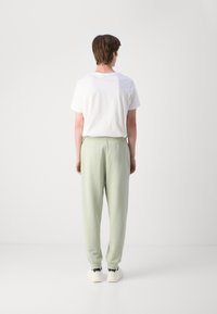 HUGO NOMPIO - Donji dijelovi trenirke - light/pastel green