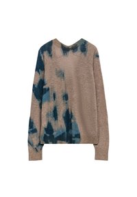 Pull en tricot avec un corps beige et un motif tie-dye bleu sur une manche. Il présente un col rond côtelé et des manches longues. Texture douce.