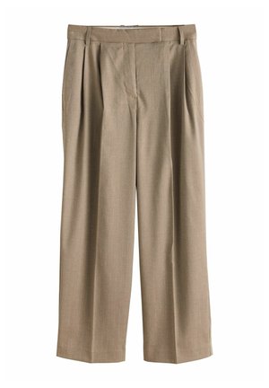 Pantalons larges beiges en tissu texturé, dotés de plis avant et d'une taille plate, sans poches ni fermetures visibles.