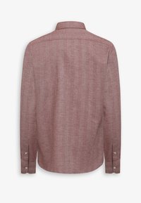 Rød struktureret skjorte med langærmer, lige kant og krave med knaplukning. Har knapper ved ærmerne og et subtilt mønster i stoffet.