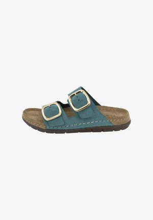 Teal suede sandal featuring two large square gold buckles, a molded cork footbed, and a brown rubber outsole with a textured grip surface.