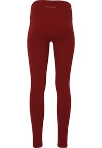 Bordeaux leggings van rekbaar materiaal met een hoge tailleband. Heeft minimale stiksels en geen zichtbare zakken of hardware.
