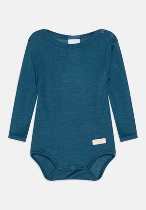 Tumesinise pintsakuga bodi, soonteksuur, ümmargune kaelus, alumised nööbid, ja väike silt "sanetta" ees.