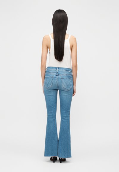 Világoskék, bőszárú farmer magas derékrésszel, két hátsó zsebbel és rojtos szegéllyel. Az anyag közepes vastagságú farmer textúrájú.