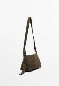 Borsa a spalla in suede verde oliva con forma triangolare, tracolla regolabile e chiusura con cerniera. Texture liscia con dettagli hardware minimi.