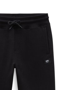 Zwarte trainingsbroek met een trekkoord in de taille, zijzakken en een stoffen label met de merknaam. Gemaakt van zacht, gestructureerd materiaal.