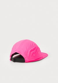 Bright pink baseball cap with a structured shape, featuring a curved visor and ventilation holes. Includes an adjustable black strap at the back.