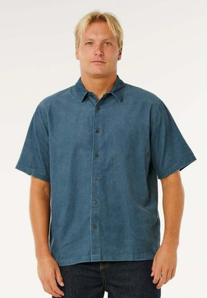 Chemise à manches courtes boutonnée en bleu foncé, en tissu texturé, avec col et boutons marron sur le devant. Coupe décontractée.