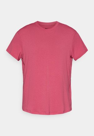 Pink short-sleeve cotton t-shirt with a crew neckline and a subtle texture, featuring a small black Nike logo on the front.