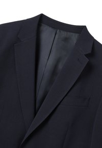 Navy blue blazer featuring a notch collar, vertical ribbed texture, and a single chest pocket. Interior lined with smooth fabric.