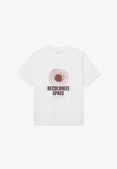 T-shirt bianco in cotone con una grafica centrale di una galassia a spirale in bordeaux e il testo "DECOLONIZZA LO SPAZIO" sottostante.