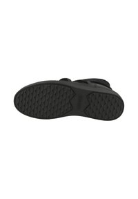 Calzado negro con suela de goma texturizada que presenta un patrón ondulado. La base es plana con un talón ligeramente elevado para mayor estabilidad.