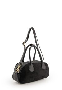Black handbag made of leather and suede, featuring rounded shape, two handles, zip closure, and gold hardware accents.