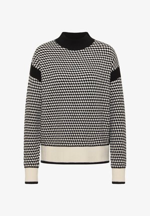 Jersey de patrón en blanco y negro con cuello y puños acanalados. Presenta un diseño texturizado y acentos contrastantes en las mangas.