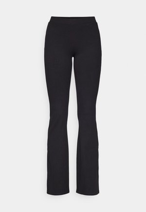 Leggings neri a costine con vita aderente e tessuto texturizzato, caratterizzati da una fascia in vita liscia e orli a campana.