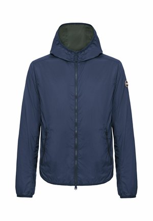 Leichte Kapuzenjacke in Marineblau mit Frontreißverschluss, seitlichen Reißverschlusstaschen, elastischen Bündchen und kleinem rundem Logopatch am linken Ärmel.