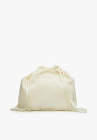 Cream canvas drawstring bag with matching ribbons, featuring a subtle logo embossed near the base, smooth texture, and simple shape.