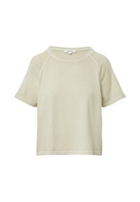 T-shirt corto a maniche corte color beige chiaro, realizzato in tessuto morbido e texturizzato. Presenta un collo rotondo e sottili dettagli cuciti lungo i bordi.