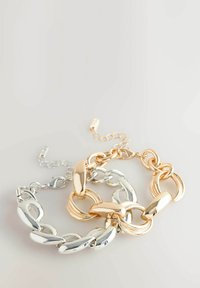 Chain bracelet set featuring interlocking silver and gold-toned links with smooth, glossy finish; includes a clasp and adjustable chain extension.