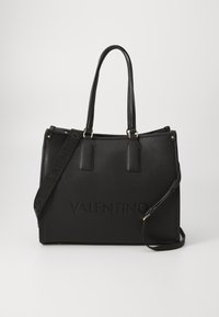 Black leather tote bag with dual handles, adjustable shoulder strap, and embossed "VALENTINO" logo on the front. Smooth texture, structured shape.