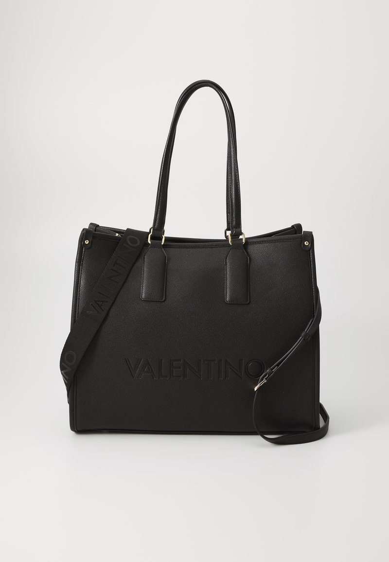 Black leather tote bag with dual handles, adjustable shoulder strap, and embossed "VALENTINO" logo on the front. Smooth texture, structured shape.