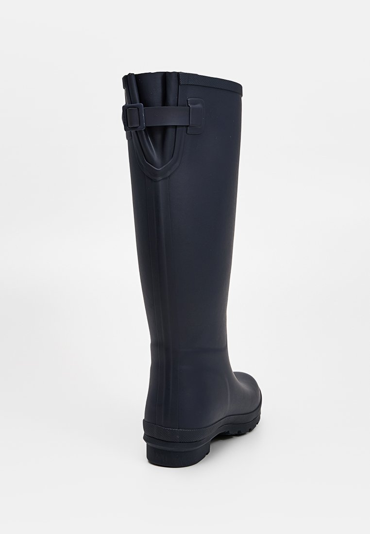 Schwarzer Gummistiefel mit glatter Oberfläche, knielangem Design und seitlichem Schnallenakzent für eine verstellbare Passform. Robuste Profillaufsohle für guten Halt.
