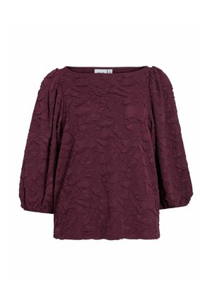 Blusa de manga larga de color ciruela con tejido texturizado y mangas ligeramente abullonadas, con un escote redondo y puños elásticos.