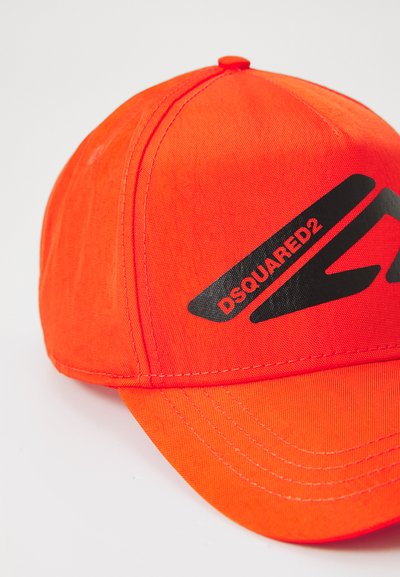Bright orange baseball cap made of fabric, featuring a black logo "DSQUARED2" and prominent stitching details on the brim and crown.