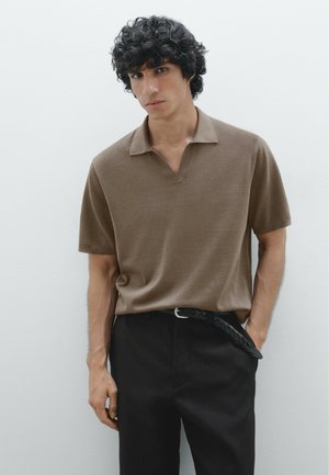 Polo shirt marrone a maniche corte con colletto a scollo a V, abbinato a pantaloni neri e una cintura intrecciata. Tessuto semplice con texture liscia.