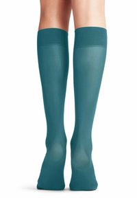 Türkisfarbene knielange Socken aus glattem, dehnbarem Material mit einem gerippten oberen Bund; verfügen über ein halbtransparentes Design und eine enganliegende Form.