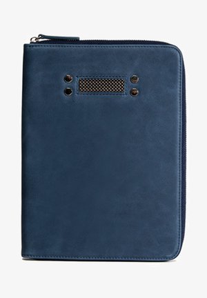 Navy blue leather zippered binder with a textured front, featuring two round metal accents and a rectangular mesh detail. Smooth finish.