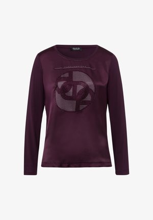 Langsleeve overhemd in diep paars, gemaakt van een soepele stof. Kenmerkt zich door een cirkelvormig, geweven ontwerp in het midden met sprankelende accenten.