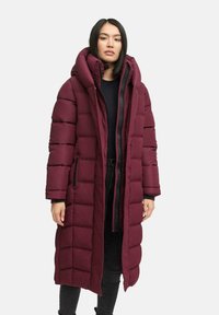 Burgundy long puffer coat with a high collar, quilted sections, two side pockets, and a full front zipper. Smooth, matte texture.