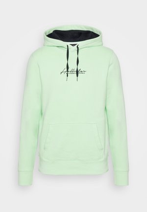 Jasnozielona bluza z kapturem z czarnymi sznurkami, przednią kieszenią i napisem "Hollister Southern California" na piersi.