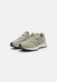 Light green suede and mesh sneakers with a textured finish, featuring a black rubber sole and a simple lace-up design.