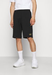EA7 Emporio Armani BERMUDA - Pantalones deportivos - black/gold-coloured