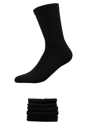 Chaussettes noires en coton avec texture côtelée, dotées d'un design de pointe sans couture. Présentées avec une pile de six paires.