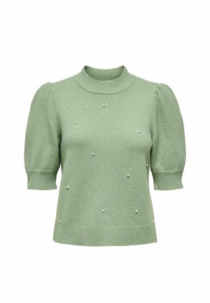 Pull en tricot vert avec des manches bouffantes courtes, un col montant et une surface texturée. Décoré de petites perles réparties de manière uniforme.