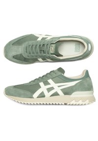 Green suede and fabric sneakers with white accents, textured upper, round toe, and serrated rubber sole. ASICS logo on tongue.