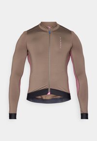 Cykeltrøje i brun med pink sidepaneler, lange ærmer, halvlynlås fortil og struktureret kant med blå accenter. Letvægts, tætsiddende design.