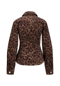 Veste en velours côtelé à motif léopard avec un col, des manches longues et deux poches au dos. La palette de couleurs comprend des tons marron et beige.