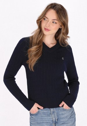 Jersey de punto navy con escote en V y mangas largas; presenta un pequeño logo de ancla en el pecho; puños y dobladillo acanalados.