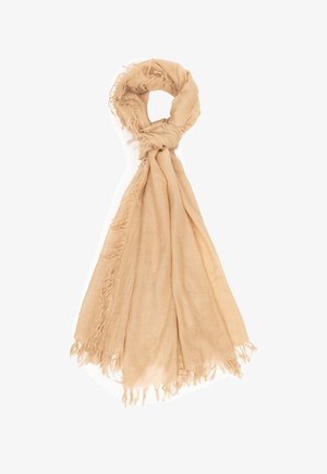 Jasnobeżowy szalik o miękkiej fakturze, luźno zawiązany na górze, z postrzępionymi brzegami i zwisającymi fałdami tkaniny.
