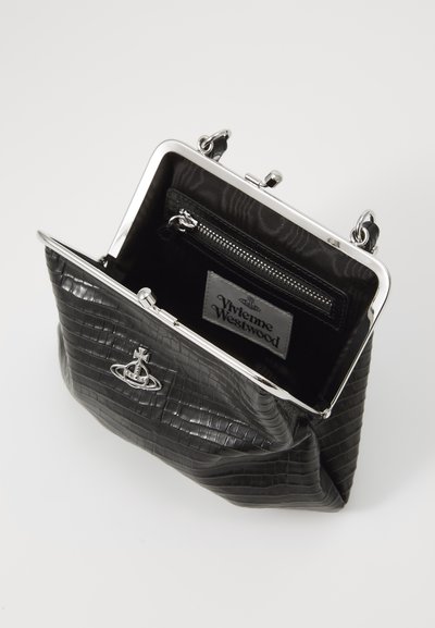 Black textured handbag with a shiny silver frame, featuring a zipper pocket and a logo tag inside. The exterior has a embossed pattern.