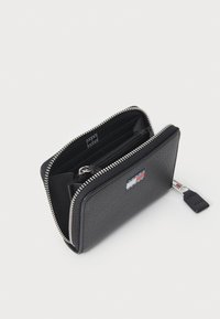 Black leather wallet with a textured finish, zip closure, and logo tag. Features multiple compartments and a small zipper pocket inside.